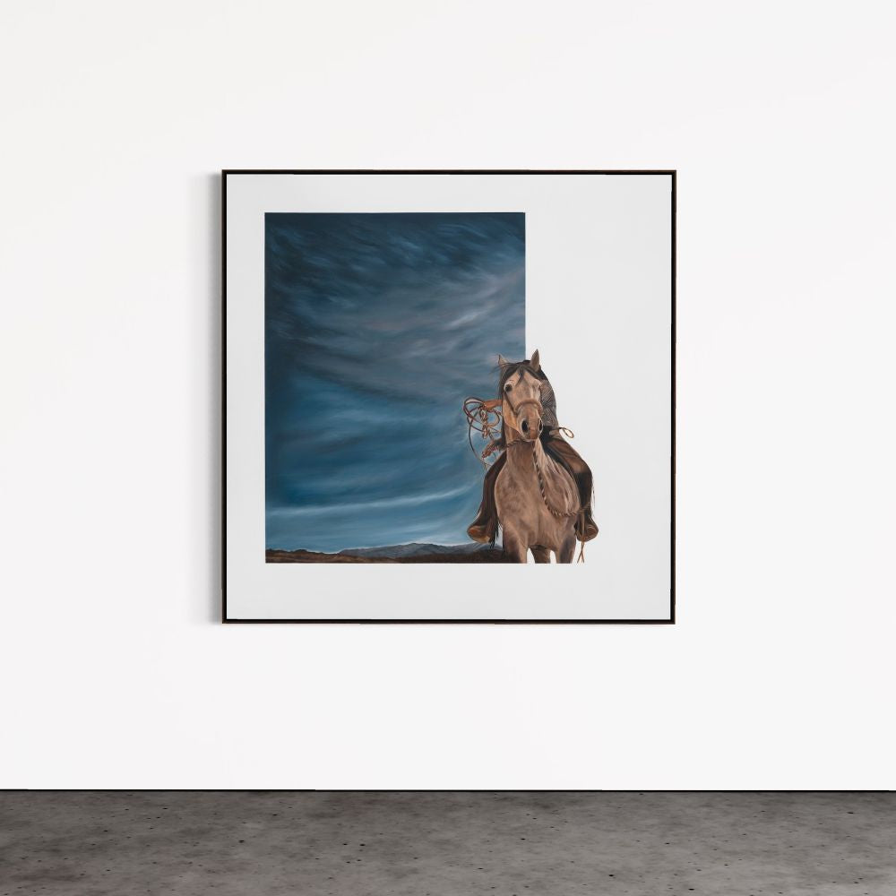 Framed artwork of a horse and rider against a blue sky with clouds.