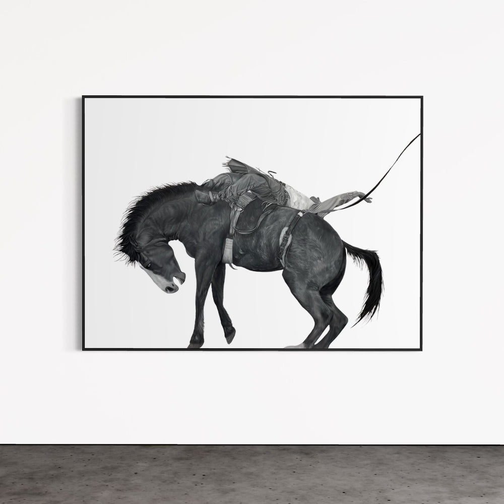 Black and white framed artwork of a horse and rider on a white wall.