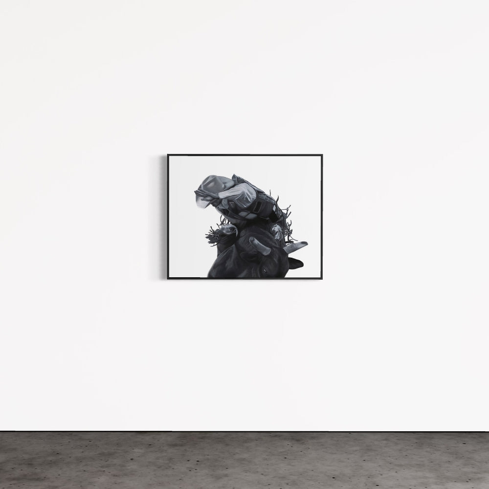 Framed black and white artwork of a person with a mask on a white wall.