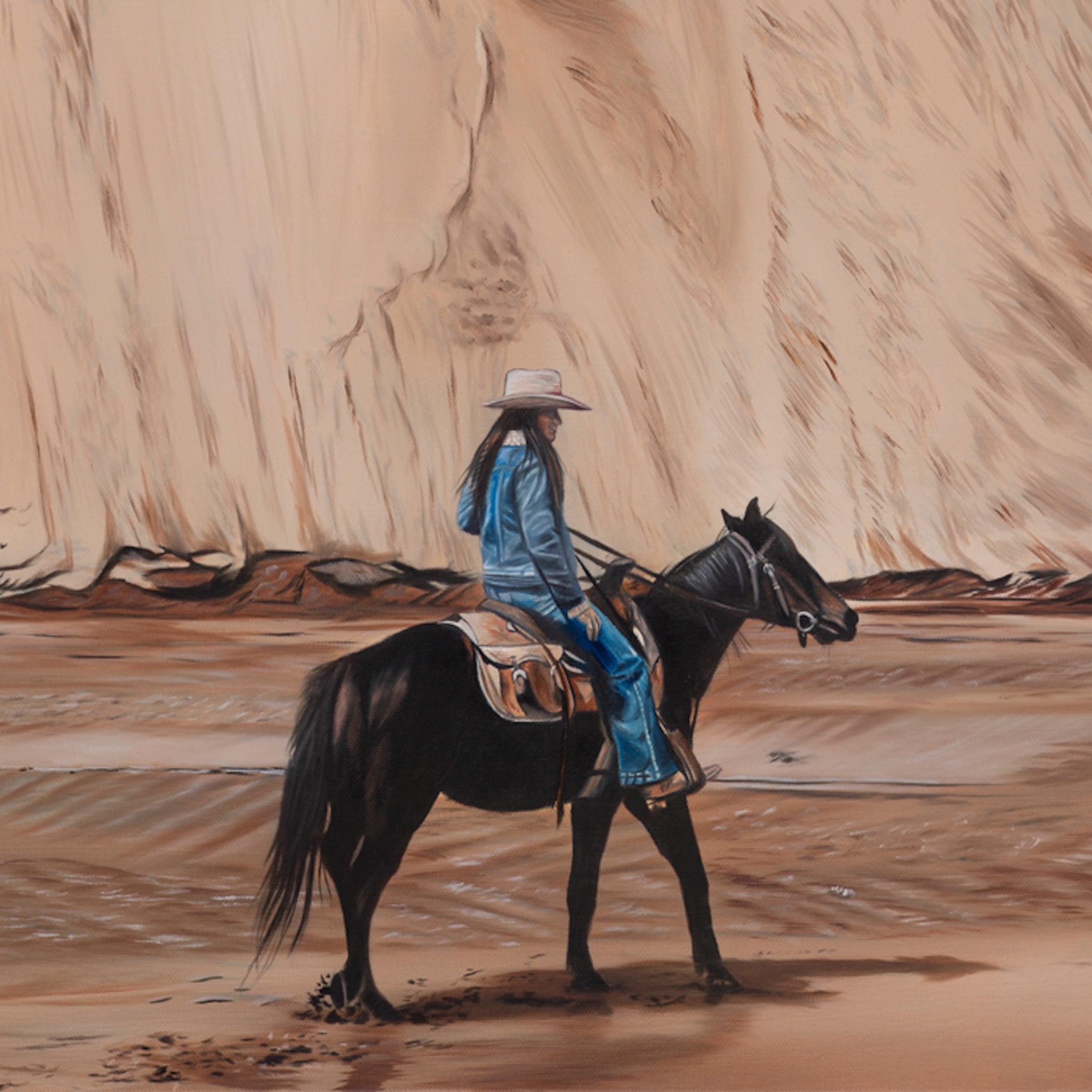 Person riding a horse in a desert landscape with large rock formations.