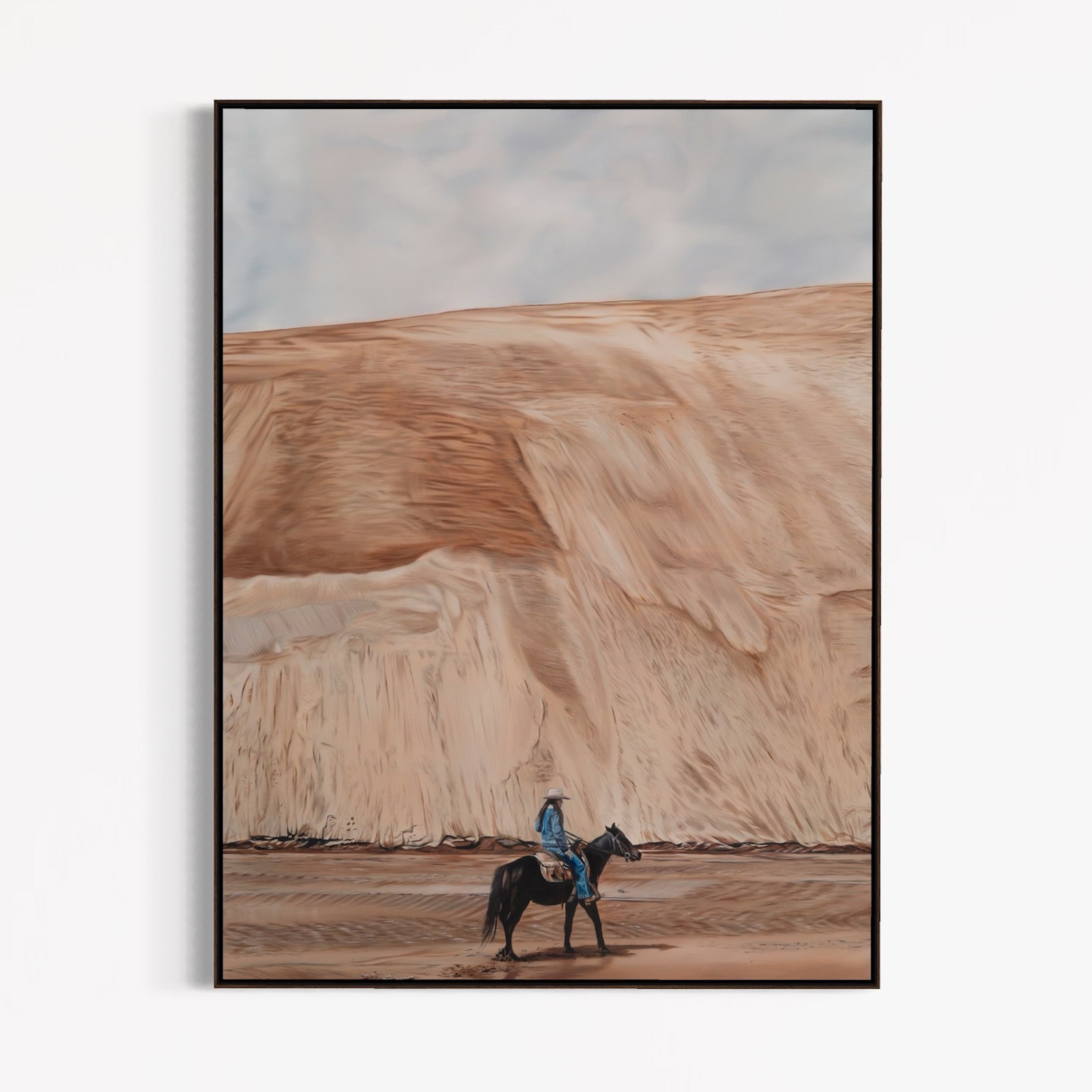 Framed artwork of a person on horseback in a desert landscape