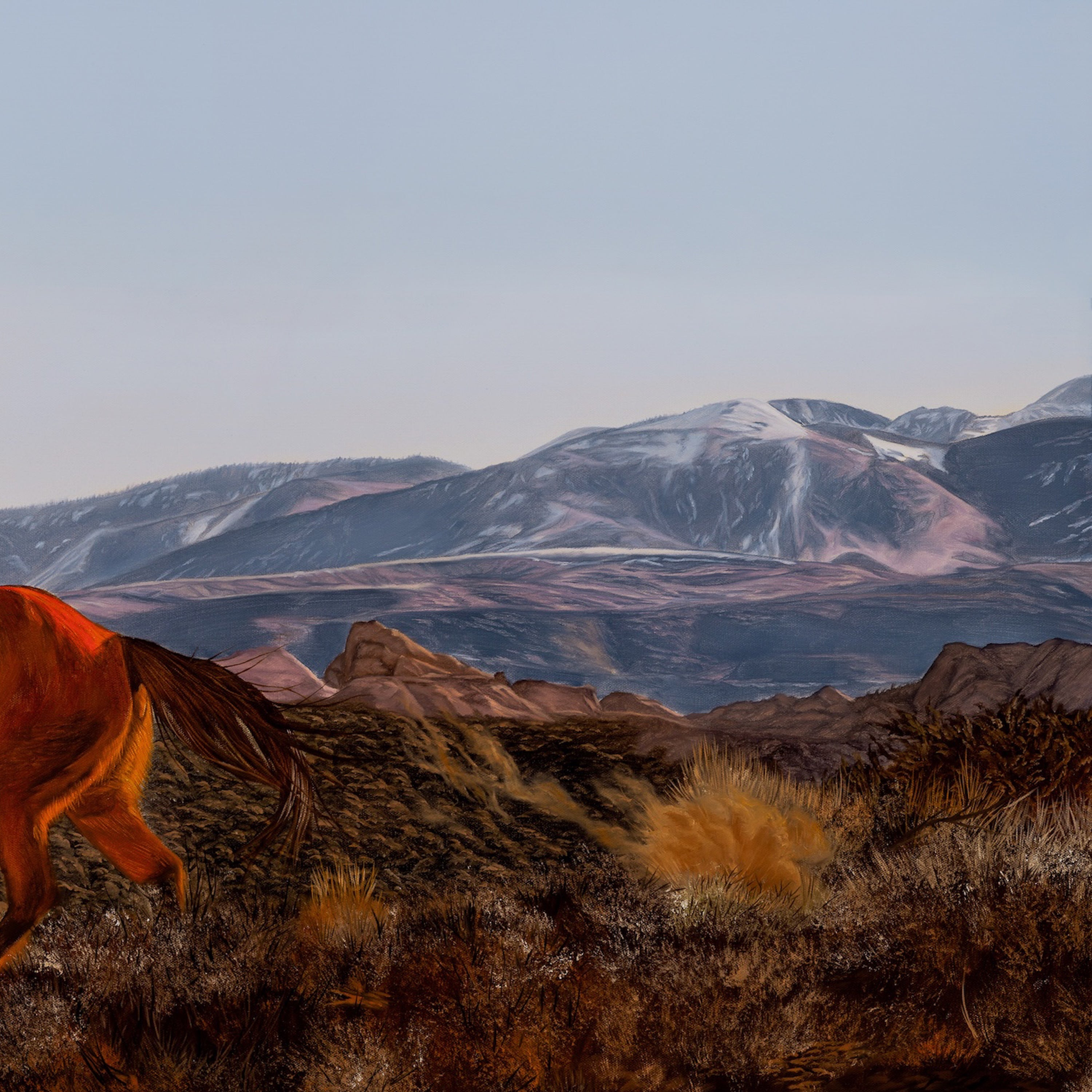 Horse in a desert landscape with mountains in the background