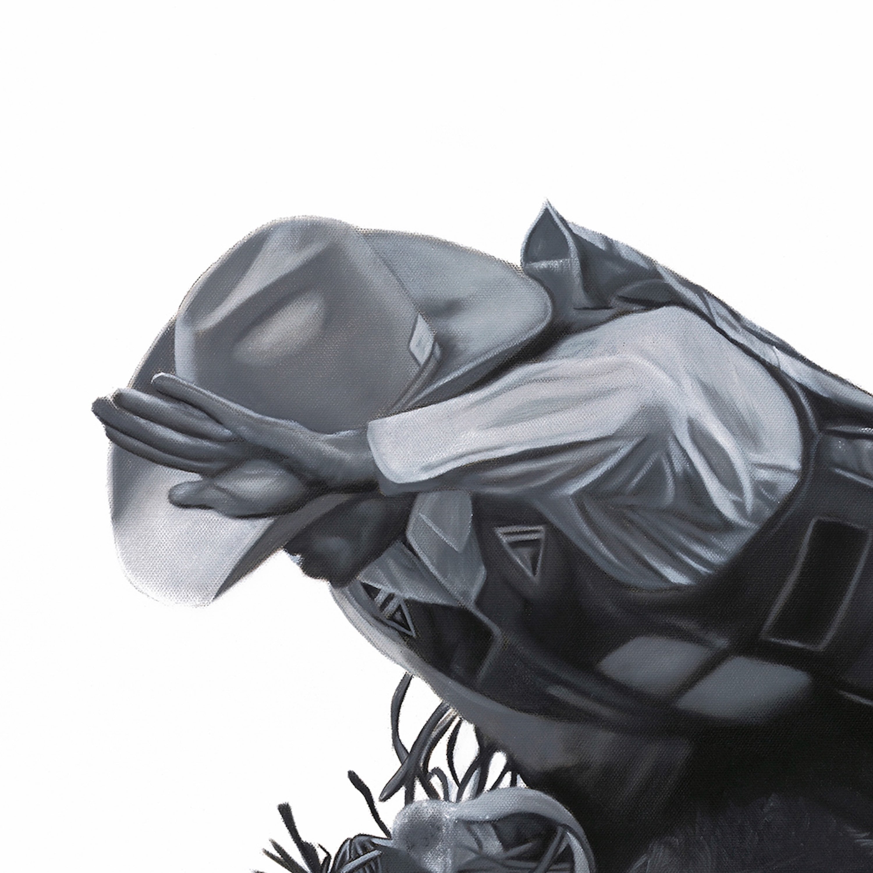 Close-up of a black and gray superhero glove with a visible brand logo on a white background