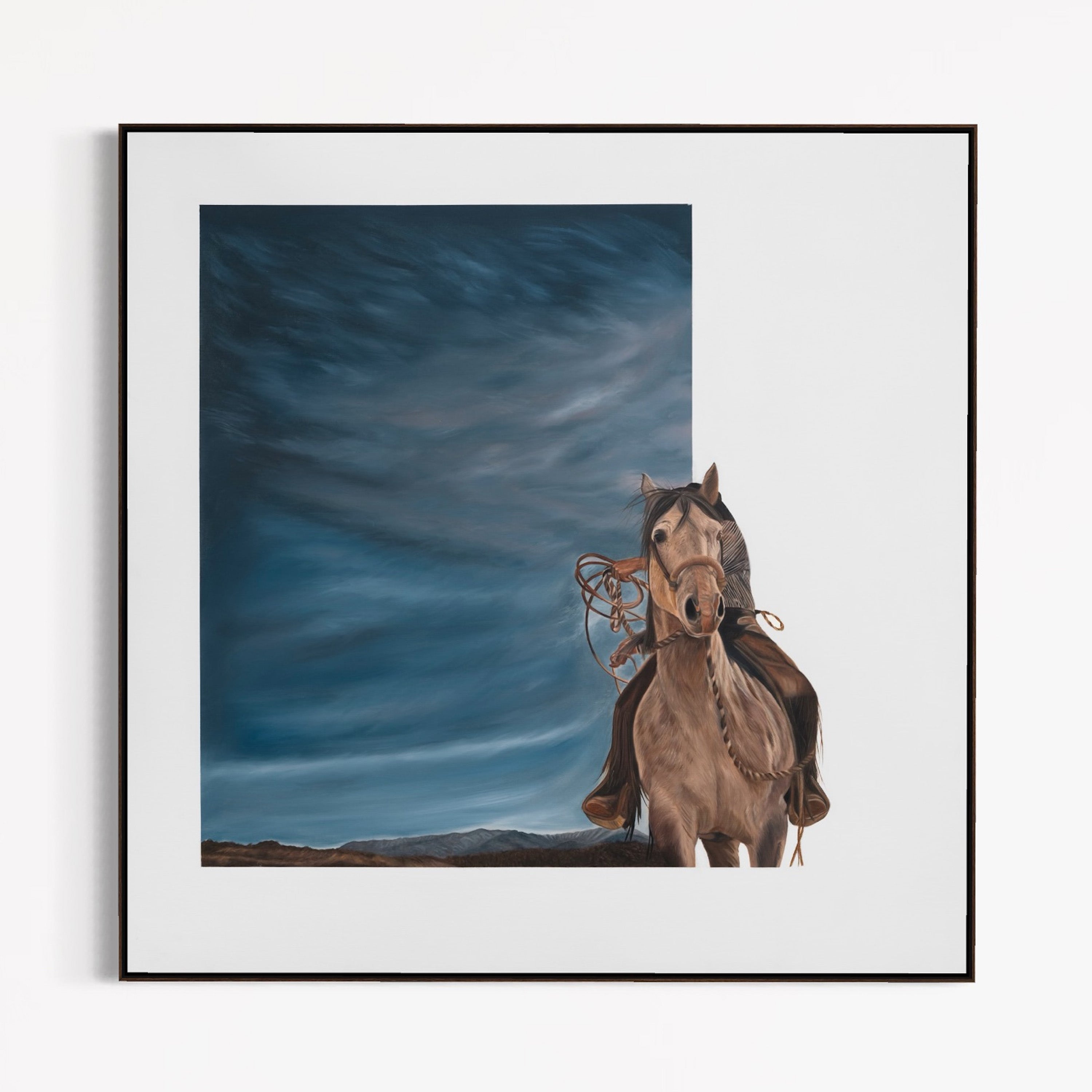 Framed artwork of a horse and rider against a blue sky.
