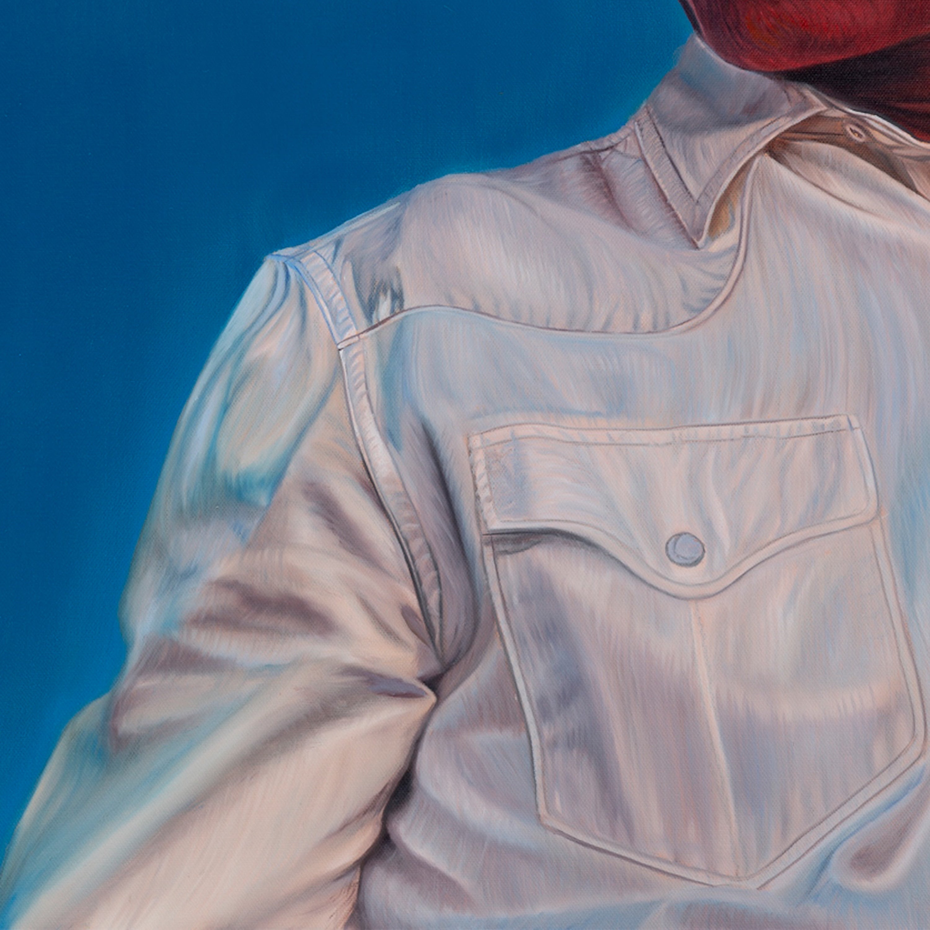 Light-colored denim jacket with a pocket on a blue background