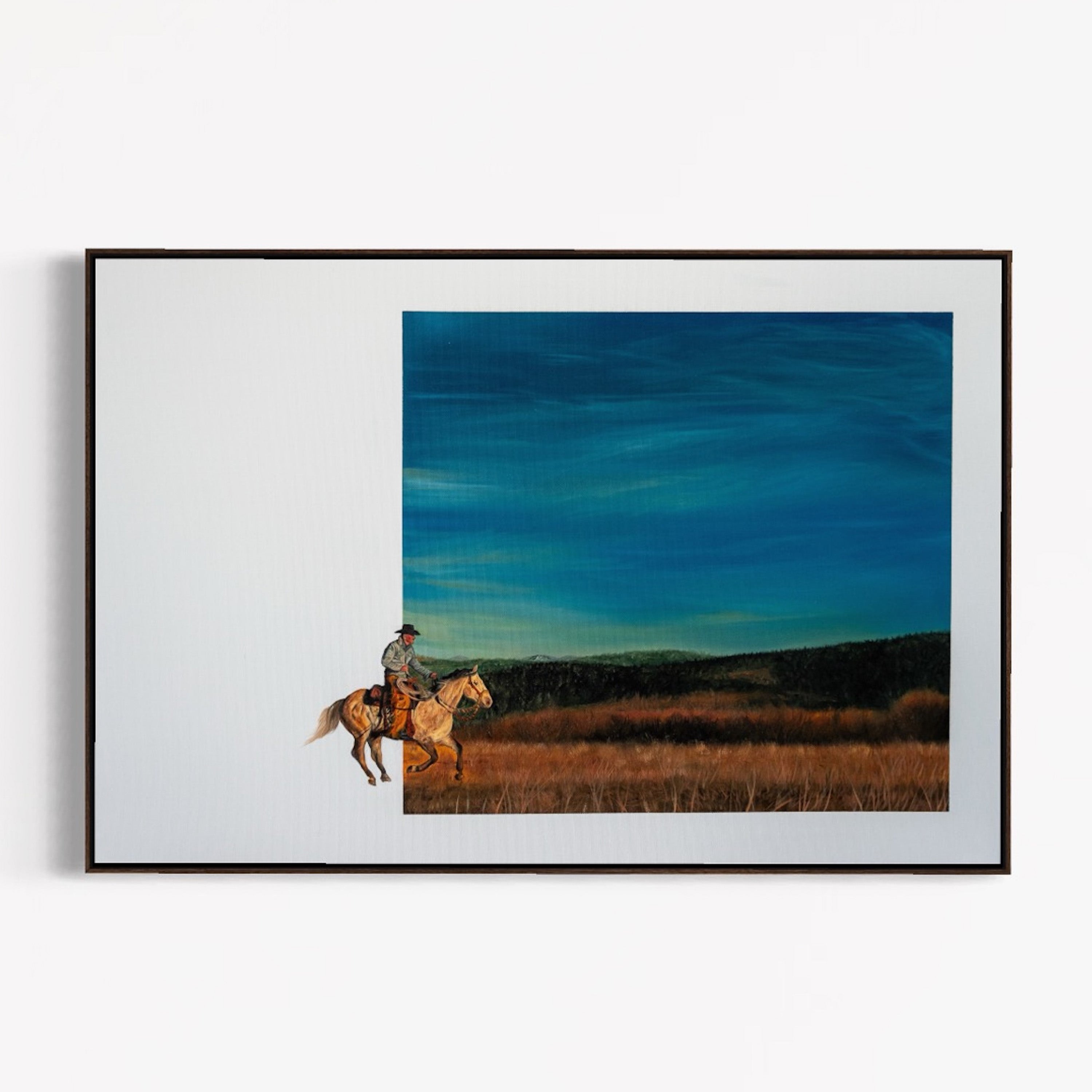 Framed artwork of a person riding a horse in a field with a blue sky.