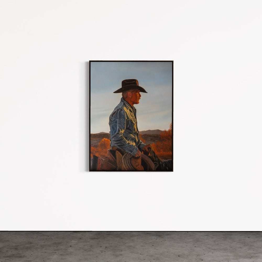Framed artwork of a cowboy sitting on a horse with a desert landscape in the background.