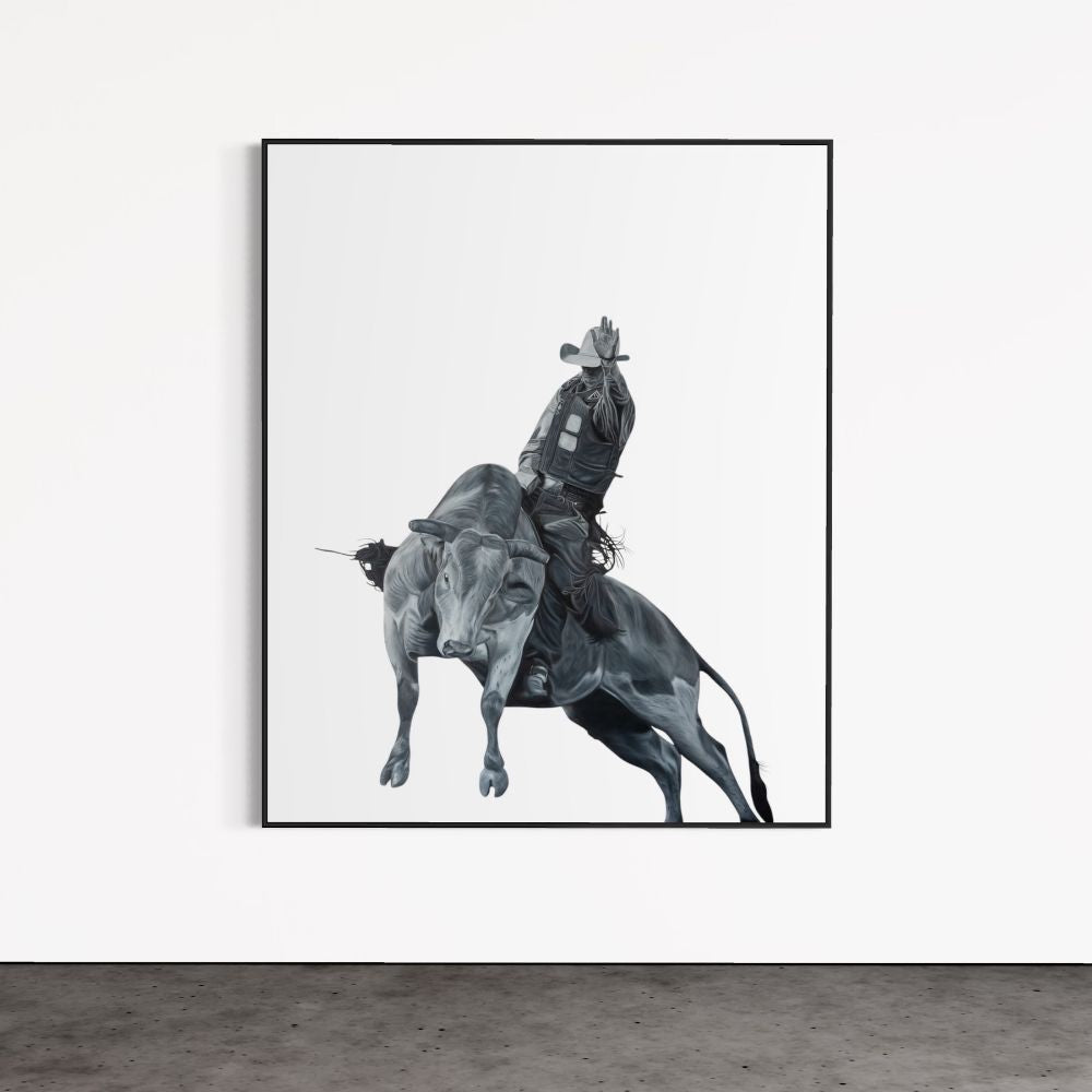 Framed artwork of a person riding a horse on a white wall.