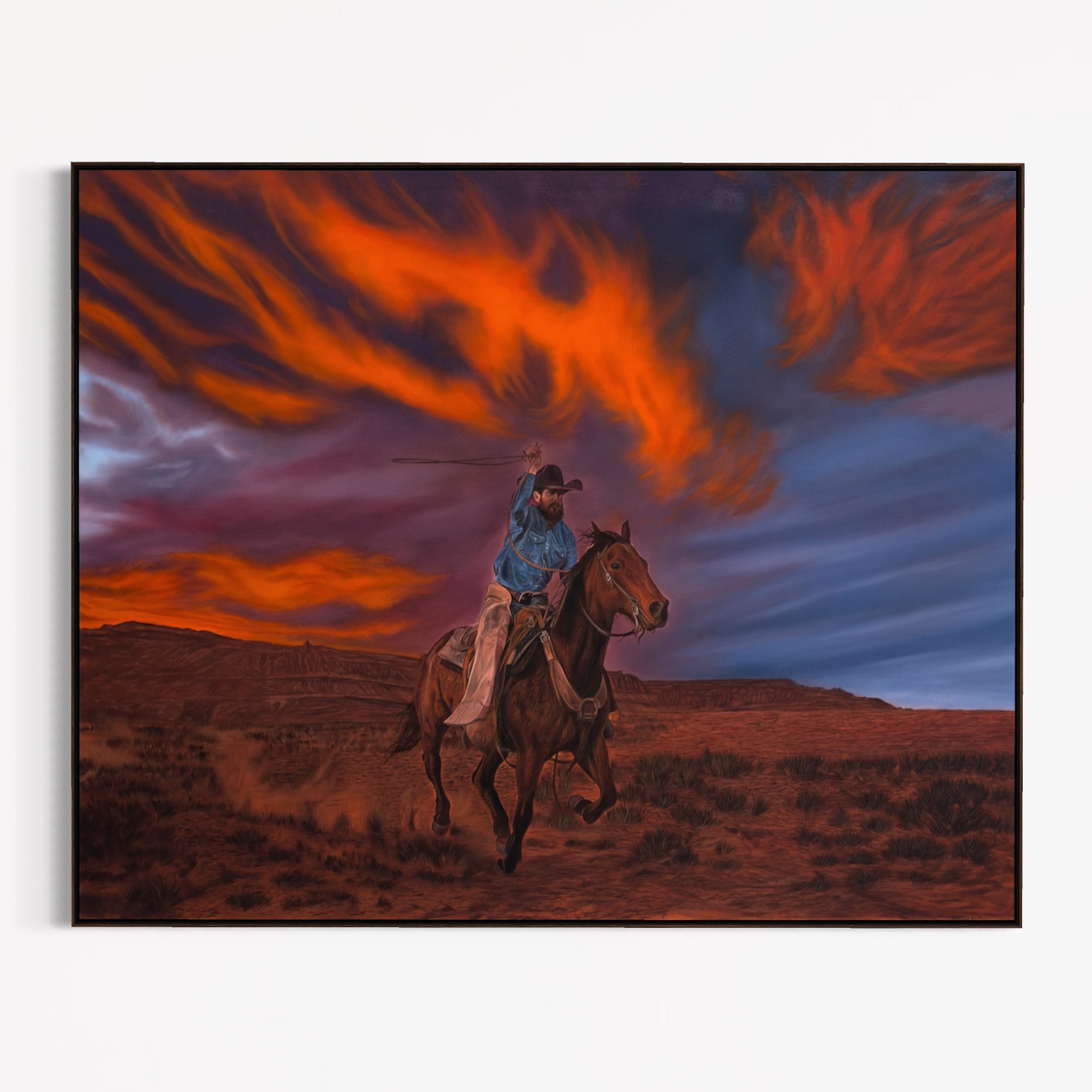 Cowboy on horseback with a dramatic fiery sky