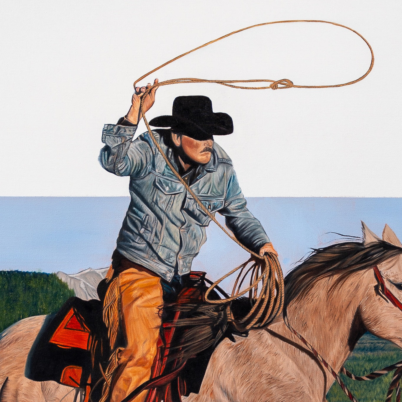 Cowboy on horseback with a lasso against a blue sky and green landscape