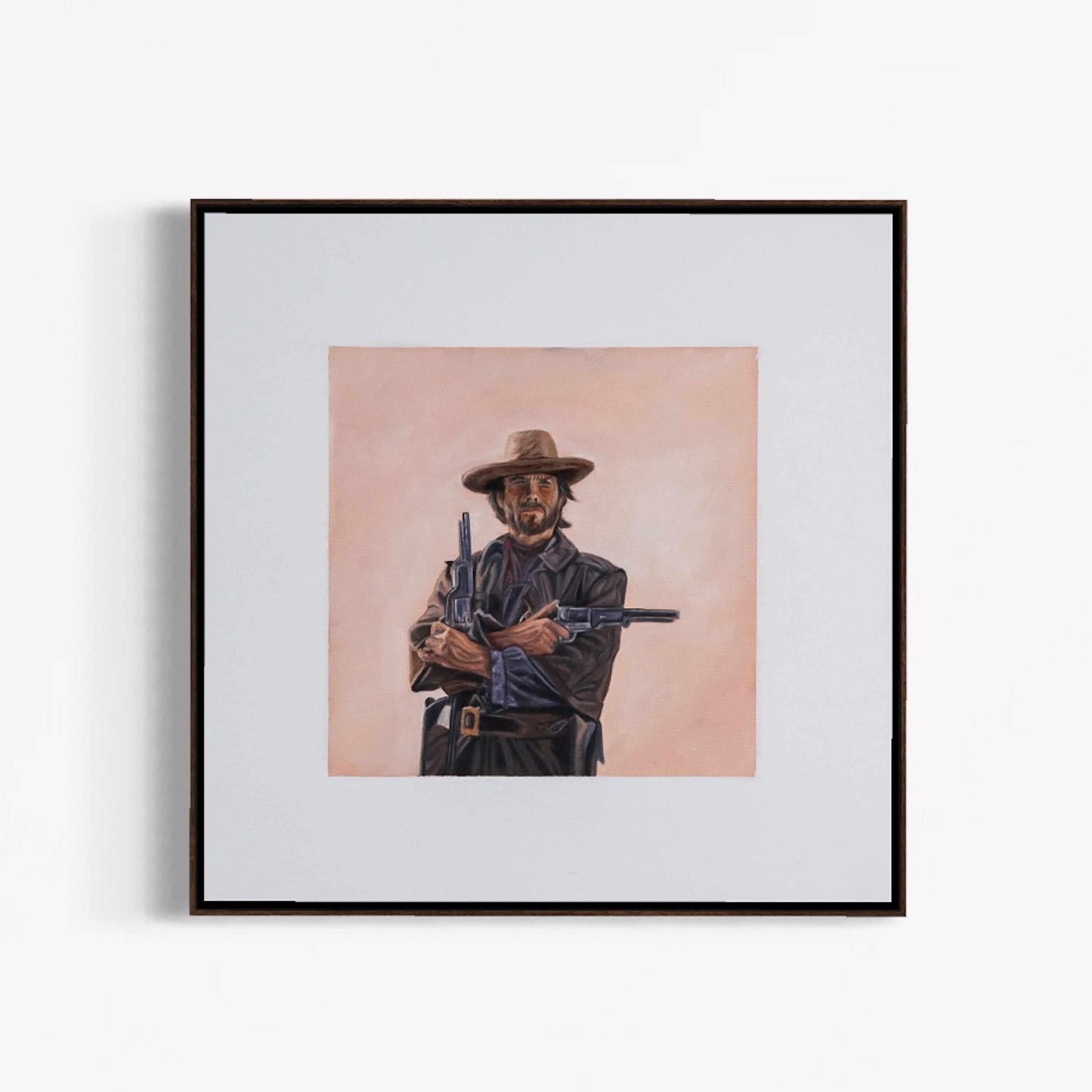 Framed artwork of a cowboy holding a rifle on a light pink background