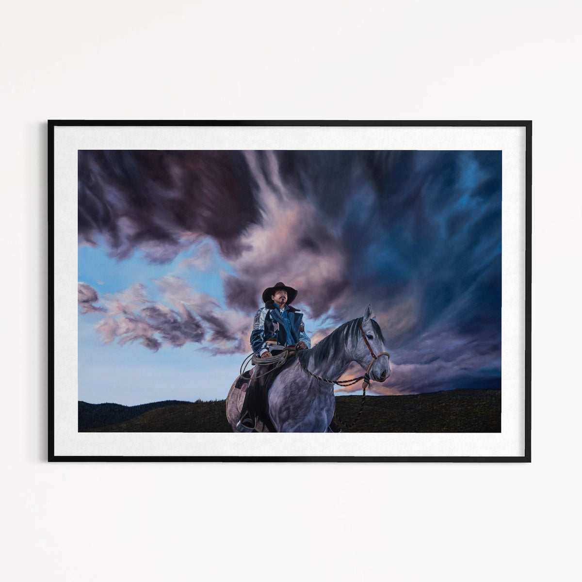 Framed artwork of a person on horseback with a dramatic sky.